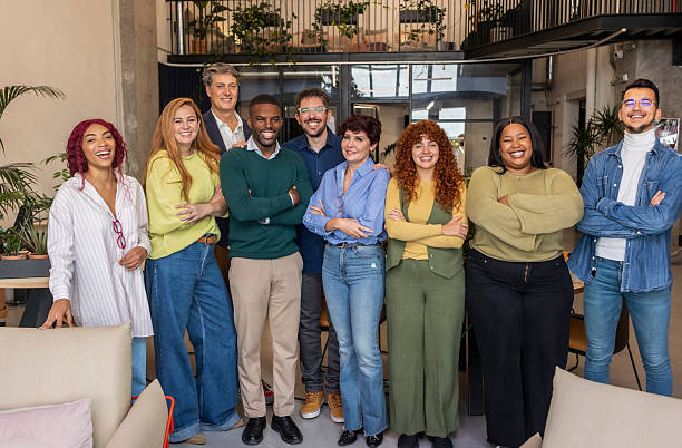 istock Confident business team smiling with arms crossed in modern office 2207318002