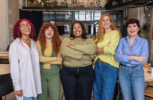 istock Five businesswomen smiling with folded arms in office 2207318003