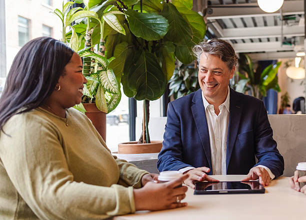 istock Business people having a meeting using a tablet in a modern office 2207318035