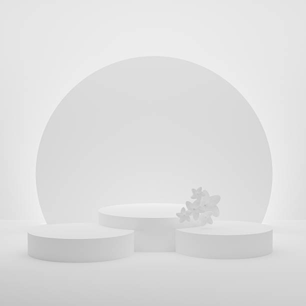 istock 3D realistic podium background - set of three white cylindrical podiums on white. White spring flowers, luminous disk as decor, mockup, 3d rendering. Spring stage for display product, scene showcase. 2207319695