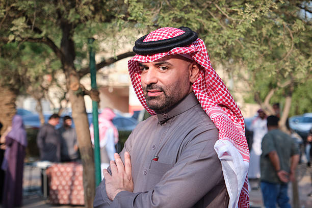 A portrait of a man in a traditional outfit at Souk Al Zel Market in Riyadh, showcasing cultural heritage and vibrant surroundings.