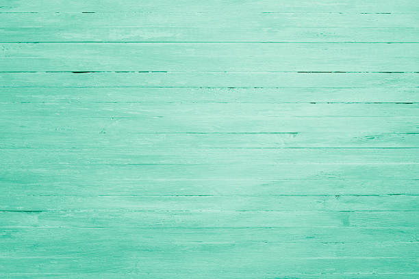 Clean and minimalistic wooden surface painted in pastel green with subtle texture and horizontal lines.
