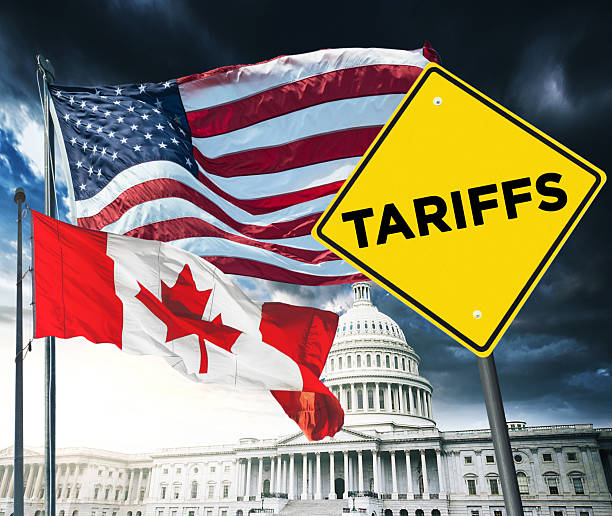 istock canadian flag against the us flag for tariffs 2207321814