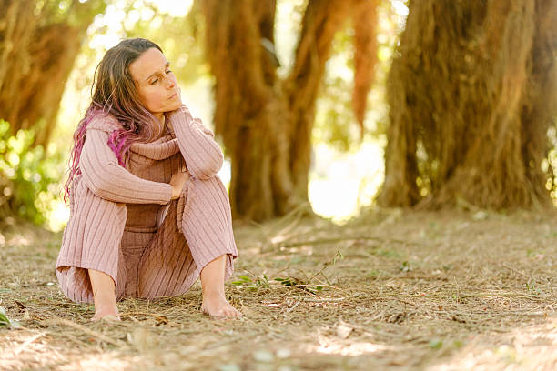 Serene woman finding peace and mindfulness amidst nature's embrace, enjoying a moment of tranquility in the woods
