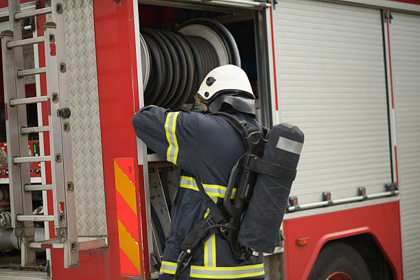 Firefighters removing an accident victim from inside the truck