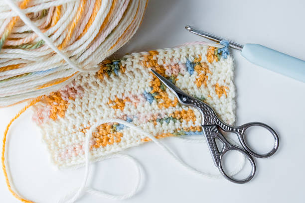 istock Close up of colorful crochet project with scissors and hook 2207326267