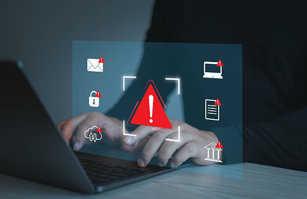 istock Businessman using laptop with spam virus with warning to alert internet security and data breach or hacker or spyware. 2207327012