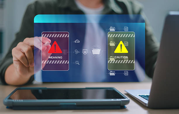 istock Businessman using laptop with spam virus with warning to alert internet security and data breach or hacker or spyware. 2207327024