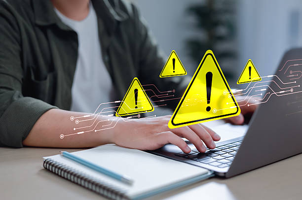 istock Businessman using laptop with spam virus with warning to alert internet security and data breach or hacker or spyware. 2207327033