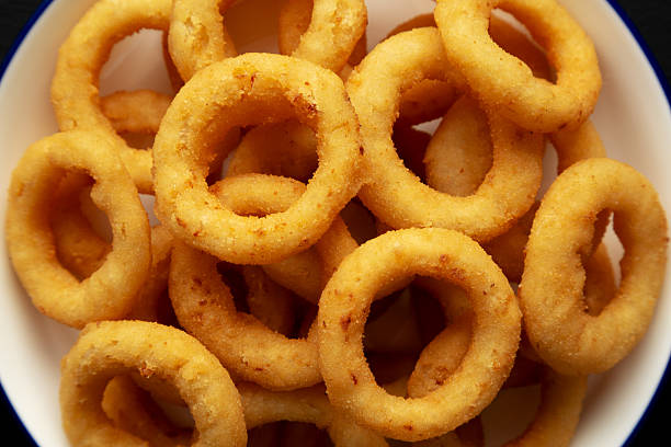 Cut Onion rings, French-fried onion ring, a form of British and American cuisine, a cross-sectional of onion dipped in batter or bread crumbs and then deep fried, a variant is made with onion paste