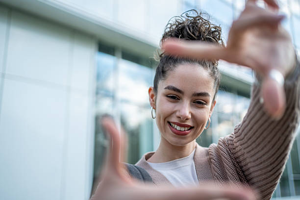 istock Young woman framing her vision with hands and smiling 2207331684