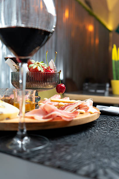 istock Platter of cold cuts, cheeses, fruit, jam and wine at the restaurant 2207332133