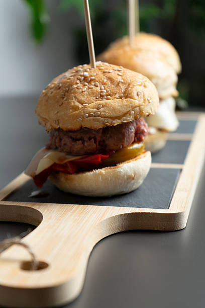istock Mini bun with meat cheese and vegetables on a plate at the restaurant 2207332149