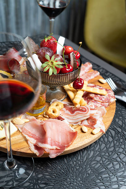 istock Platter of cold cuts, cheeses, fruit, jam and wine at the restaurant 2207332173