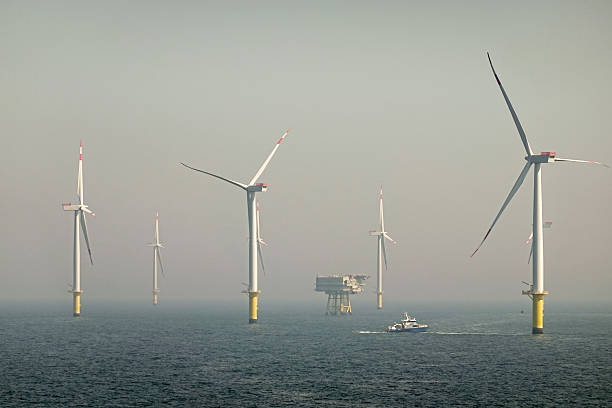 istock Epic view over Offshore Wind farm and substation on the horizont, vessel between them, bright sky, Borkum Riffgrund Germany 2207332263