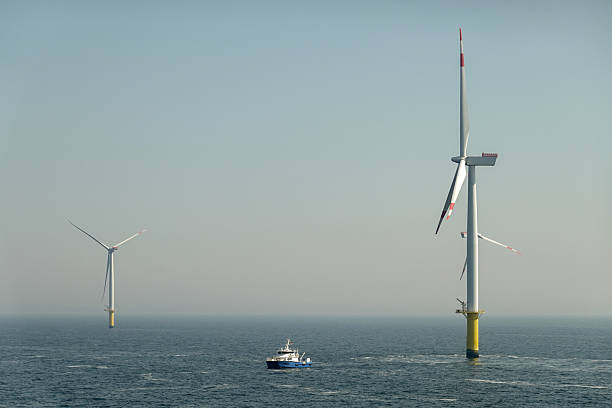 istock Renewable Energy in the Ocean: Two wind turbines and passenger vessel between them. 2207332272