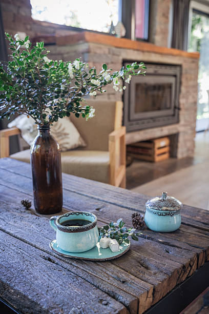 istock Living room in a mountain house, rustic style, with salamander, coffee cup. 2207332423