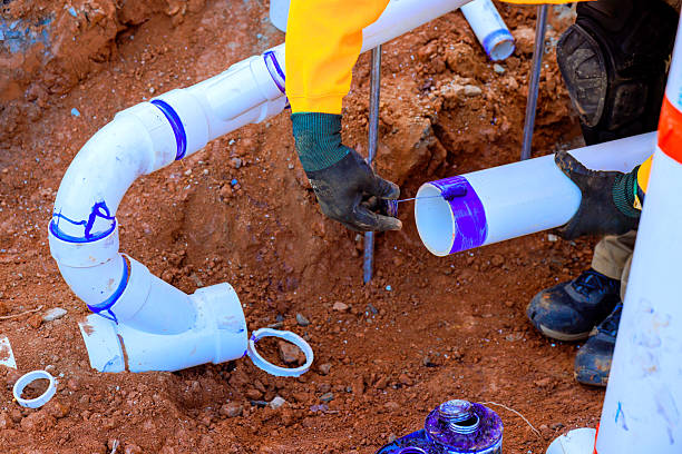 istock Workers installing new PVC pipes in a construction site during daytime in an urban area 2207333491
