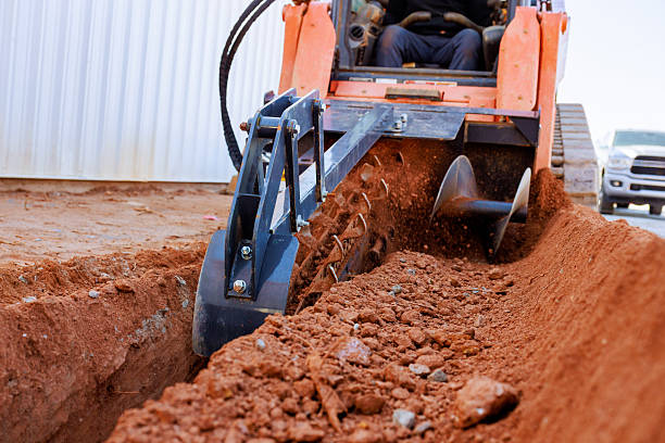istock Excavation work using a trencher at a construction site in the afternoon sun 2207333512