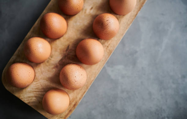 istock Fresh Brown Eggs on Rustic Wooden Tray 2207334394