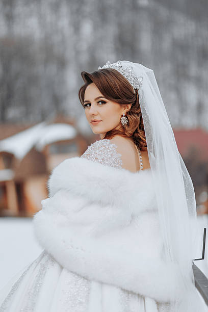 istock A woman in a white fur coat and a white veil 2207337949