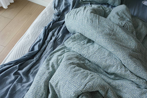 istock messy bed in early morning , messy bed after waking up 2207340672