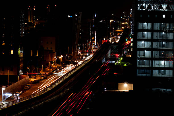 Illuminated cityscape of Riyadh including the vibrant city lights and Riyadh Metro viewed at night.