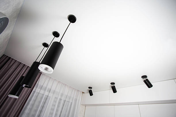 istock Modern suspended ceiling with different black LED lamps on a white ceiling in the kitchen. Copy space for text, illumination 2207343090