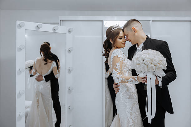 istock A bride and groom are posing for a picture in front of a mirror 2207344331