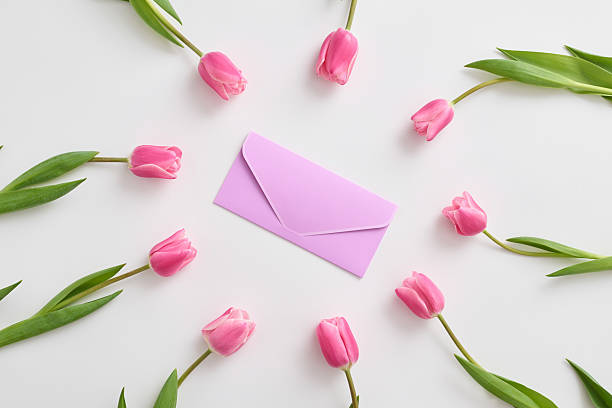istock Tulips are elegantly arranged around a purple envelope symbolizing love, gratitude and the joy of motherhood. 2207344442