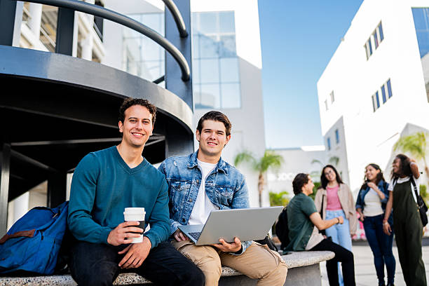 istock Portrait of young students men using laptop at university 2207348415