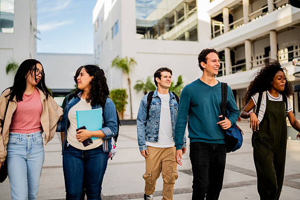 istock Young student friends talking and walking at campus 2207348449