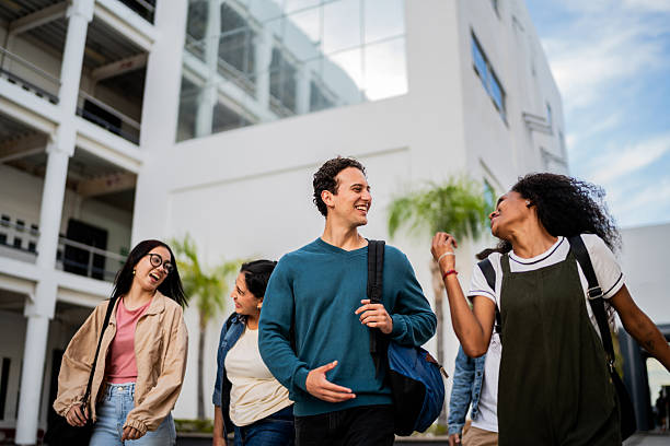 istock Young student friends talking and walking at campus 2207348470