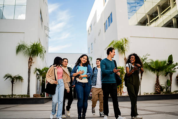 istock Young student friends talking and walking at campus 2207348475