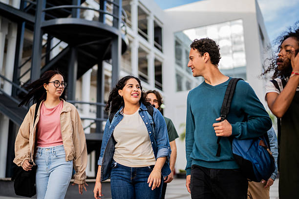 istock Young student friends talking and walking at campus 2207348482