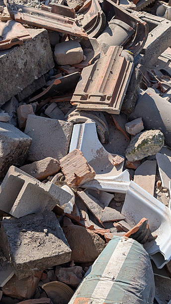 istock Construction debris and rubbles stock on a waste disposal site for recycling. Vertical. Selective waste sorting and population environmental responsibility concept. 2207348731