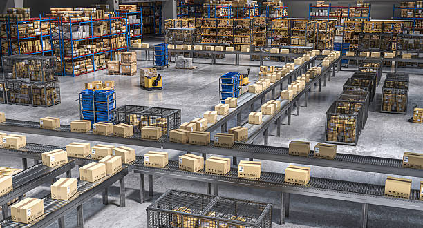 istock Cardboard boxes moving on conveyor belt in distribution warehouse 2207352699