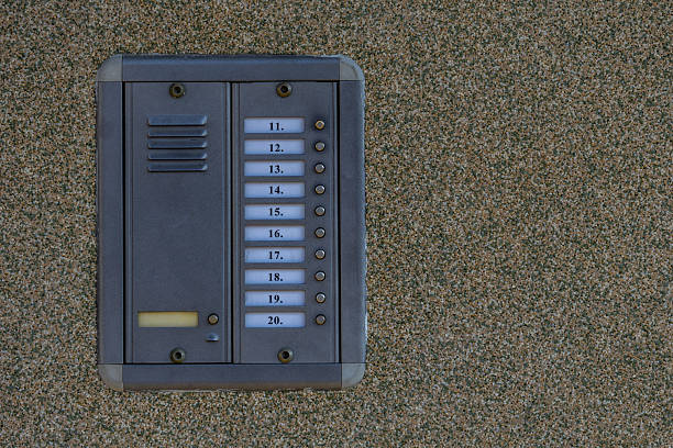 Combination lock control panel, intercom with microphone on the wall at the entrance to the house