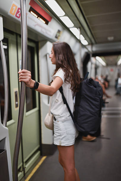 istock Female Backpacker Driving in Metro Holding Rail for Balance 2207353857