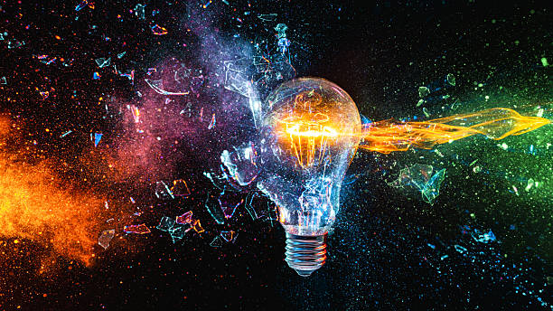 istock Broken light bulb is releasing colorful energy and ideas 2207354675