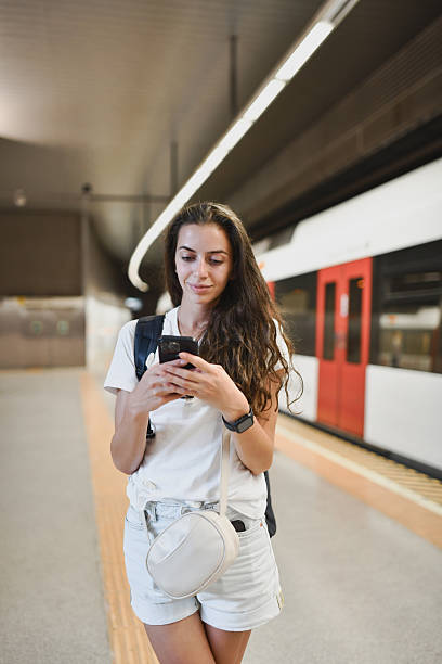 istock Beautiful Female Checking Touristic Attractions on Phone After Exiting Metro 2207354816