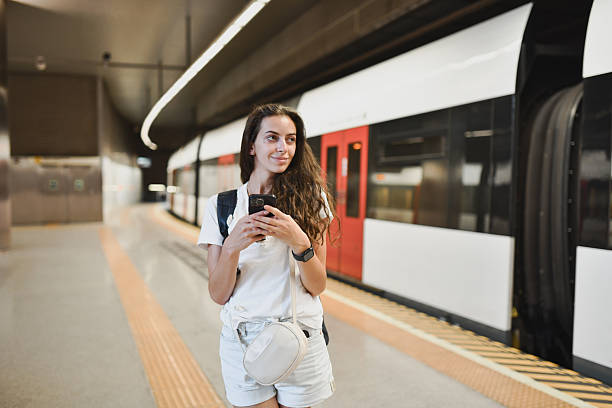 istock Woman Checking Her Smartphone for Local Attractions After Exiting Metro 2207354845