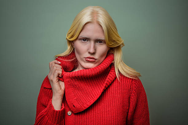 istock Albina poses confidently in a red turtleneck sweater against a muted green backdrop 2207357835