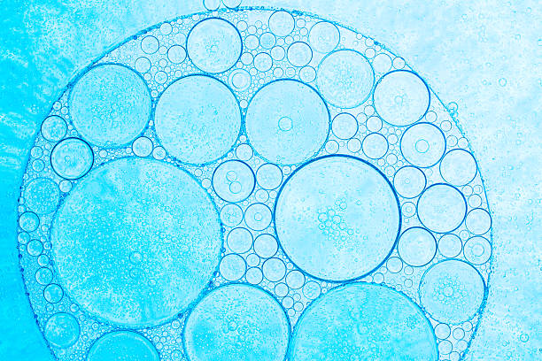 istock Macro blue bubble texture,Oil droplets creating bubbles,pattern and an art image with shadow effect caused by lighting and colour on light blue coloured background. 2207358369