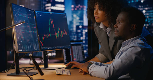 istock Investment manager discusses opportunities with the analyst, exploring potential stock changes 2207359436