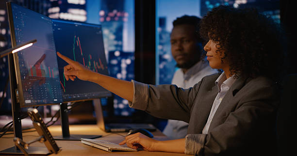 istock Investment manager discusses opportunities with the analyst, exploring potential stock changes 2207360063