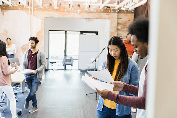 istock Multiracial Group of People Reviewing Documents Together in Office 2207360842