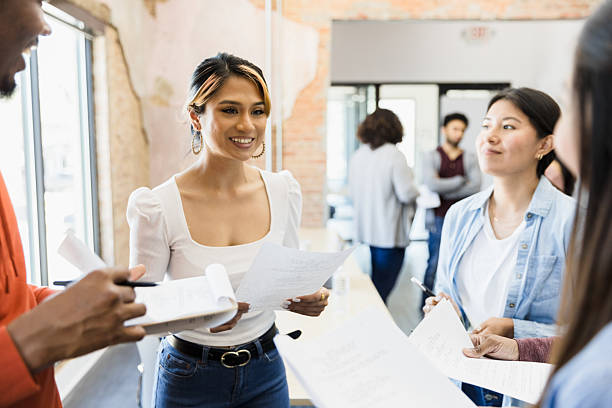 istock Multiracial Group of Young Adults Discussing Documents in Office 2207360852