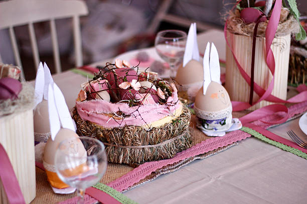 istock Easter pink handmade bunnies decorate the holiday table, Easter table setting 2207361439