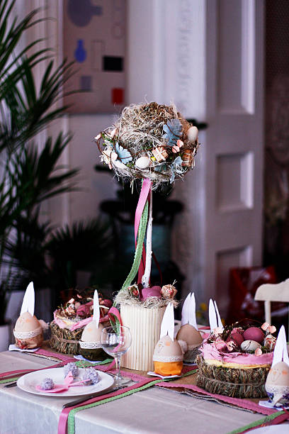istock Easter table setting with round topiary trees and ribbons in pink colors 2207361449